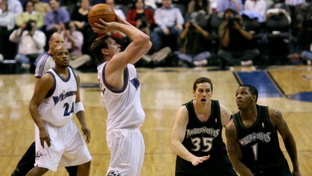 Darius Songalia of the Washington Wizards shoots the ball in a game vs. the Minnesota Timberwolves. In background: Jarvis Hayes (Washington), Mark Madsen, and Rashad McCants (both Minnesota).