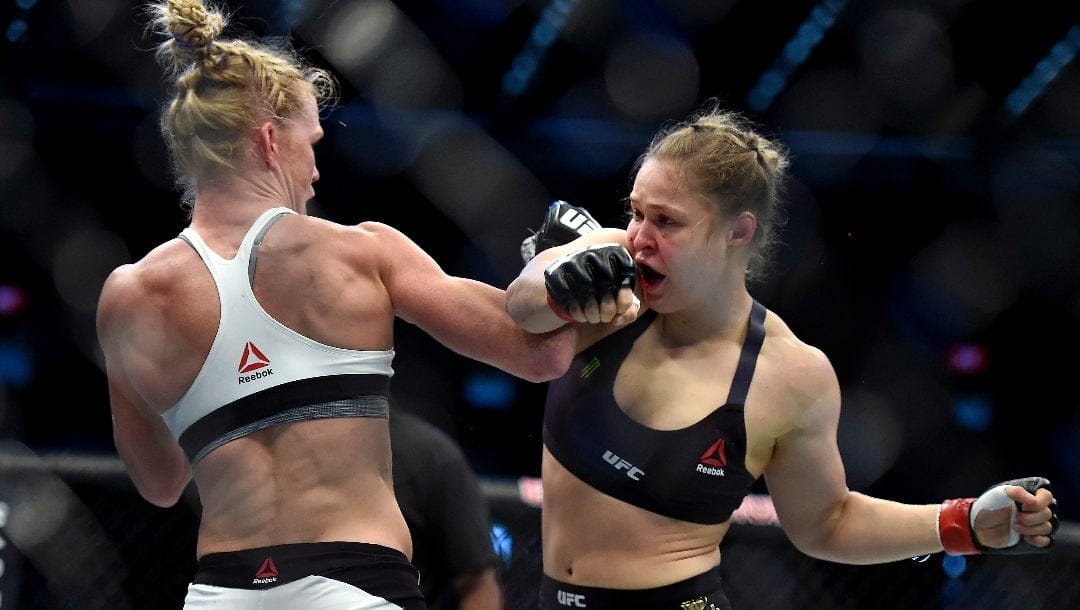 Holly Holm, left punches Ronda Rousey during their UFC 193 Bantamweight title fight in Melbourne, Australia, Sunday, Nov. 15, 2015.