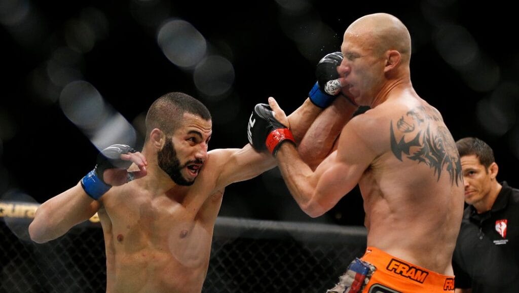 John Makdessi punches Donald Cerrone during their lightweight mixed martial arts bout at UFC 187 on Saturday, May 23, 2015, in Las Vegas.