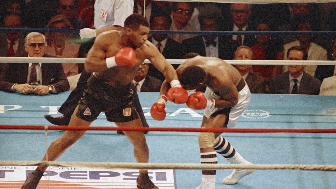 Mike Tyson is signaled to the neutral corner by referee Frank Capuccino following his first round knockout of Michael Spinks in their world heavyweight title fight in Atlantic City, N.J., June 27, 1988.