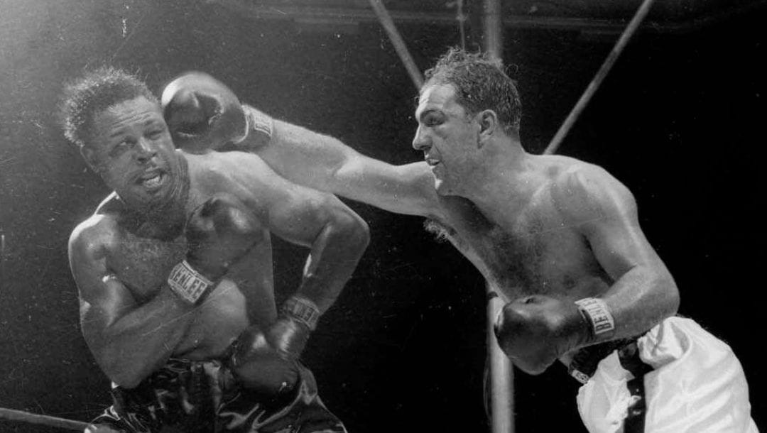 World heavyweight champion Rocky Marciano, delivers a right, that was followed by a left, that sent challenger Archie Moore.