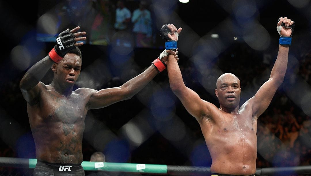 Nigeria's Israel Adesanya, left, reacts after defeating Brazil's Anderson Silva during their middleweight bout at the UFC 234.