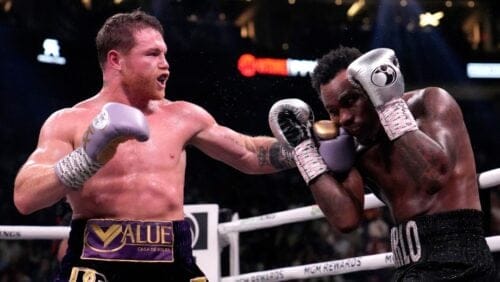 Canelo Alvarez, of Mexico, left, fights Jermell Charlo in a super middleweight title boxing match, Saturday, Sept. 30, 2023.