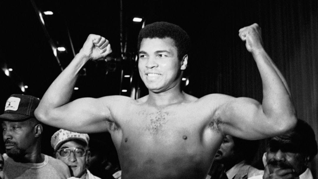Heavyweight champion Muhammad Ali raise his fists on Wednesday, Sept. 28, 1977 during his weighing-in ceremony in New York.