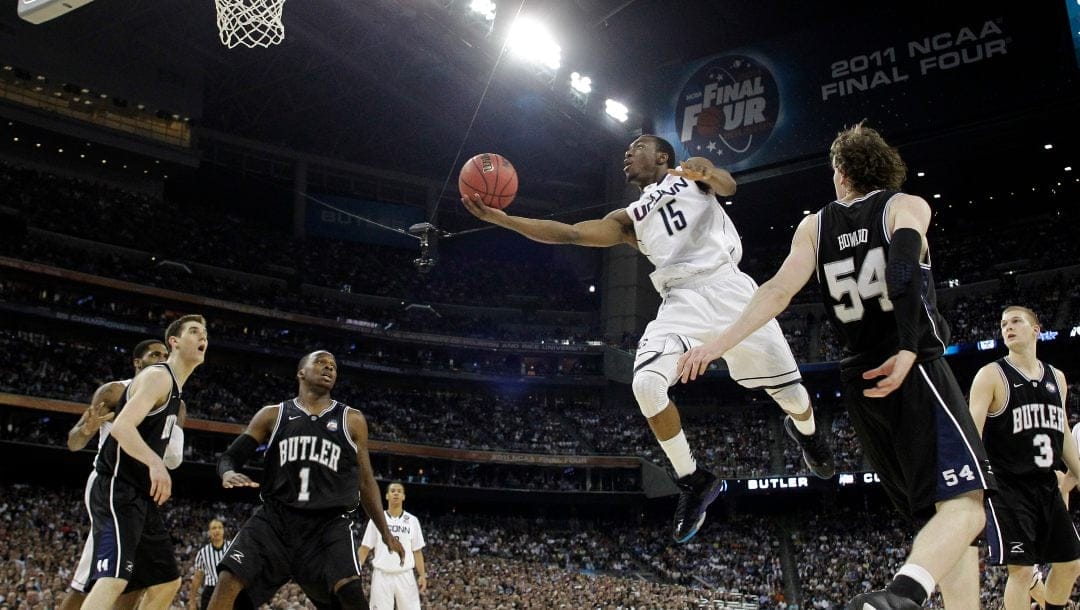 Connecticut's Kemba Walker shoots as Butler's Matt Howard defends during the second half of the men's NCAA Final Four college basketball championship game Monday, April 4, 2011, in Houston.