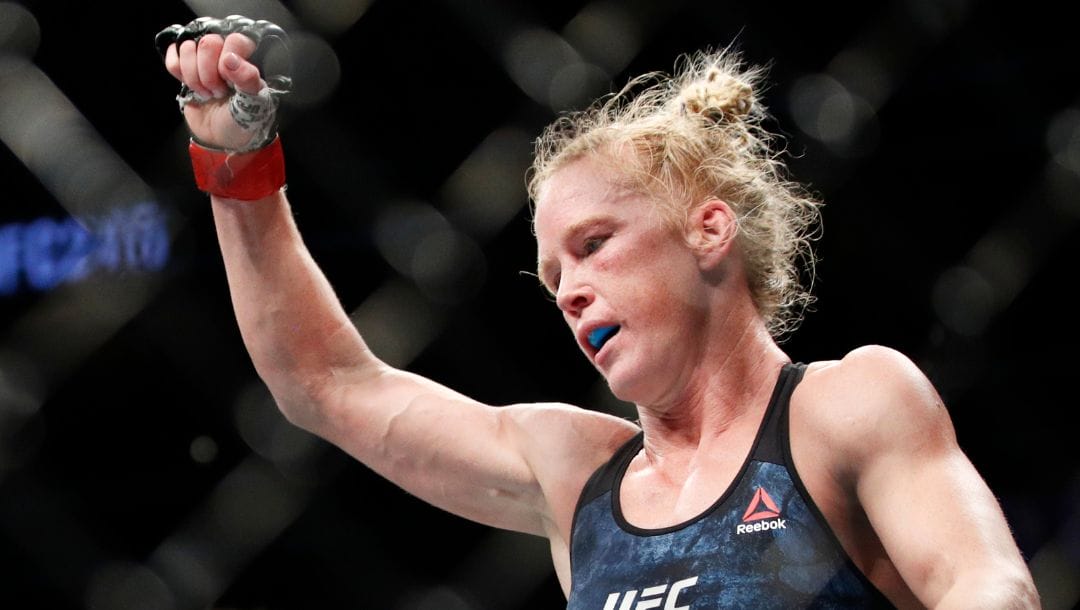 Holly Holm celebrates after defeating Raquel Pennington during a UFC 246 women's bantamweight mixed martial arts bout.