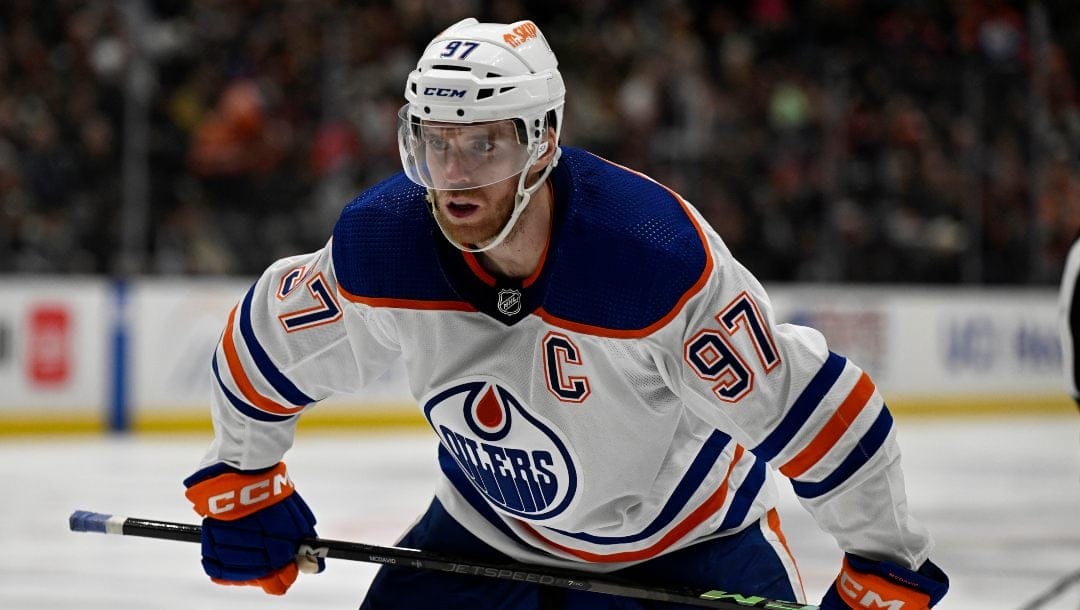 Edmonton Oilers center Connor McDavid readies for a face off against the Anaheim Ducks during the second period of an NHL hockey game in Anaheim, Calif., Friday, Feb. 9, 2024.