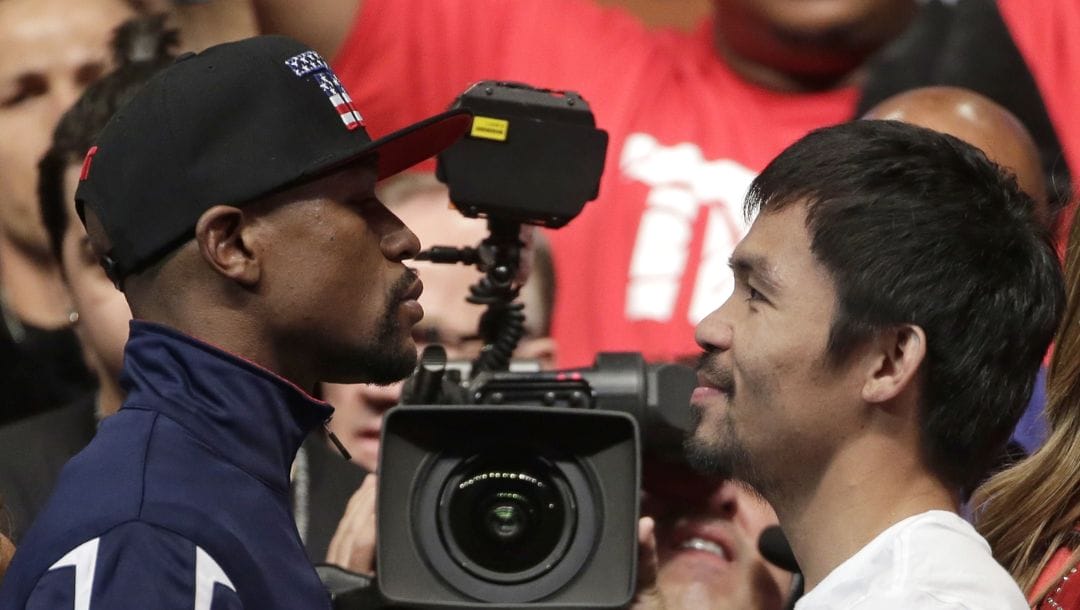 Floyd Mayweather Jr., left, and Manny Pacquiao pose during their weigh-in on Friday, May 1, 2015 in Las Vegas.