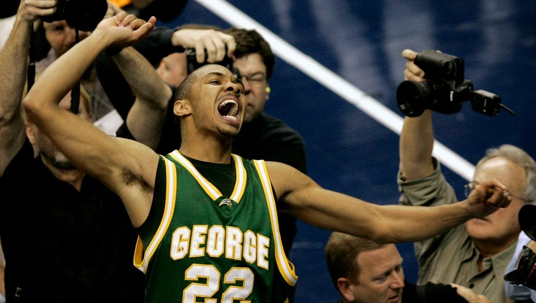 George Mason's Lamar Butler (22) reacts after beating Connecticut 86-84 in overtime during the fourth round game of the NCAA basketball tournament in Washington, Sunday, March 26, 2006.