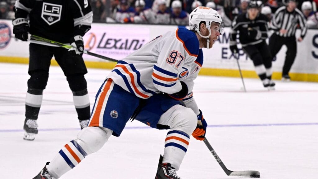 Edmonton Oilers center Connor McDavid (97) controls the puck against the Los Angeles Kings during the third period of an NHL hockey game in Los Angeles, Saturday, Feb. 10, 2024.