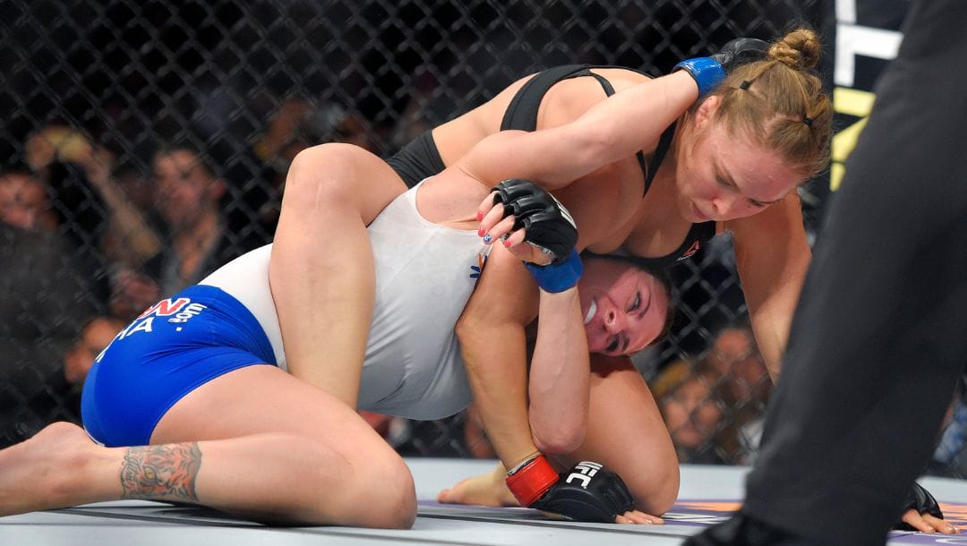 FILE - In this Feb. 28, 2015 file photo, Ronda Rousey, right, grapples with Cat Zingano in a UFC 184 mixed martial arts.