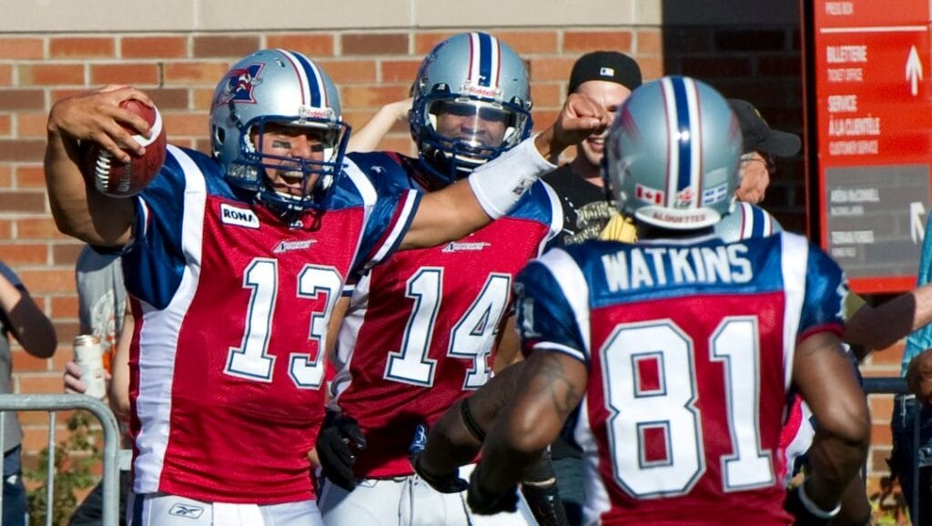 Montreal Alouettes quarterback Anthony Calvillo celebrates after scoring a touchdown against the Toronto Argonauts with teammates Brandon London, rear, and Kerry Watkins, right, during third quarter CFL football action Monday, October 10, 2011 in Montreal.