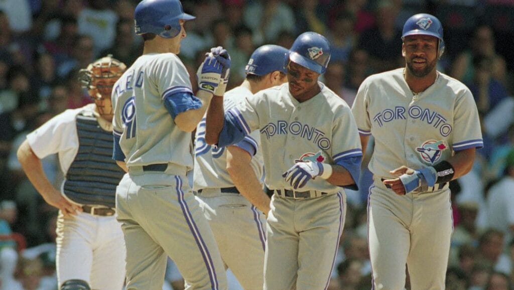 Toronto Blue Jays Tony Fernandez, center, acquired Friday from the New York Mets, is congratulated by John Olerud, left, and Joe Carter, right, after hitting a three-run homer in the fourth inning off Detroit Tigers David Haas in Detroit, Sunday, June 13, 1993.