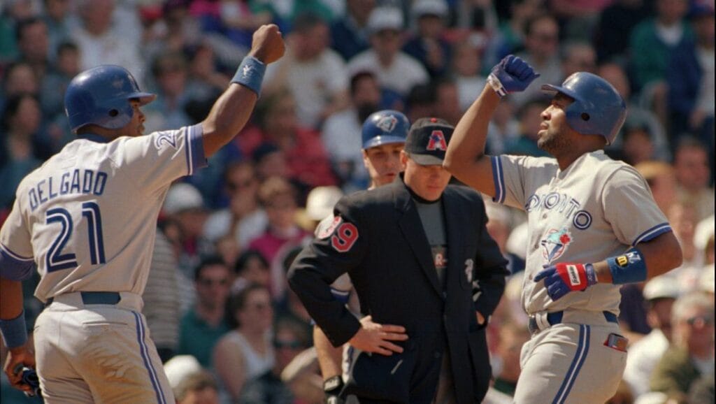 Toronto Blue Jays Joe Carter, right, gets congratulated by teammate Carlos Delgado, left, after hitting a two-run home run against the Boston Red Sox in the fourth inning, Sunday, May 5, 1996 at Boston's Fenway Park.