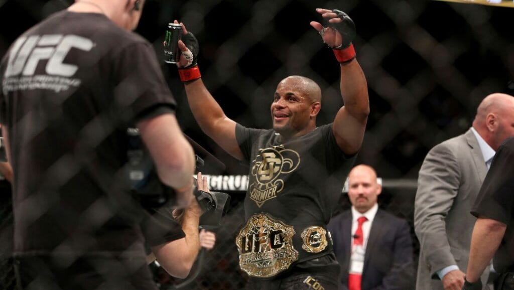 Daniel Cormier wears the belt after a win over Volkan Oezdemir in a light heavyweight championship mixed martial arts bout.