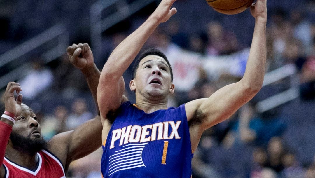 Devin Booker with the Phoenix Suns attempts a layup during a game against the Washington Wizards on November 21, 2016.