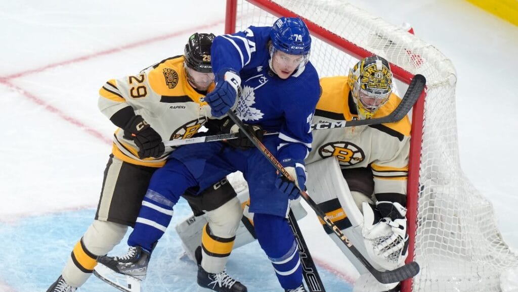 Boston Bruins defenseman Parker Wotherspoon (29) and Toronto Maple Leafs center Bobby McMann (74) vie for position in front of Bruins goaltender Jeremy Swayman (1), right, in the second period of an NHL hockey game, Thursday, March 7, 2024, in Boston.