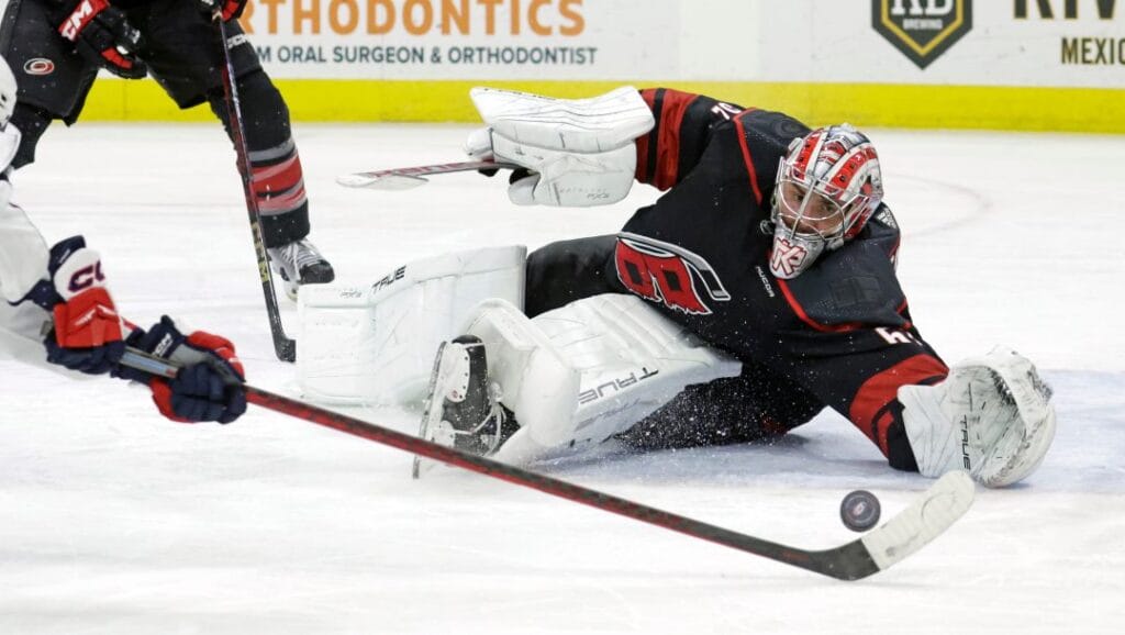 Carolina Hurricanes goaltender Pyotr Kochetkov (52) stops a shot by Washington Capitals center Dylan Strome, left, during the third period of NHL hockey game Friday, April 5, 2024, in Raleigh, N.C.
