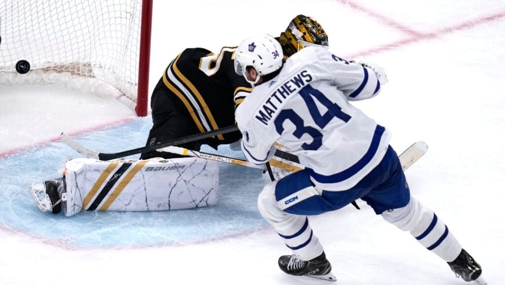 Toronto Maple Leafs center Auston Matthews (34) beats Boston Bruins goaltender Linus Ullmark, back, for a goal during the third period of Game 2 of an NHL hockey Stanley Cup first-round playoff series, Monday, April 22, 2024, in Boston.