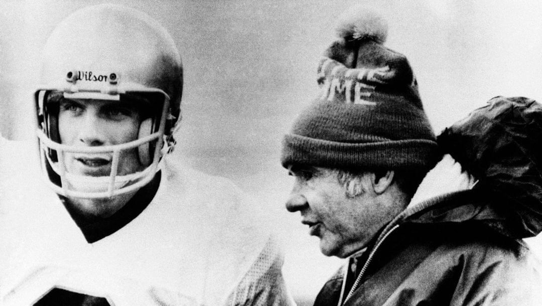 Notre Dame quarterback Joe Montana has a last minute talk with head coach Dan Devine in closing minutes of game with the University of Houston at Cotton Bowl classic on Jan. 2, 1979 in Dallas, Texas. Notre Dame won the hard-fought game 35- 34.