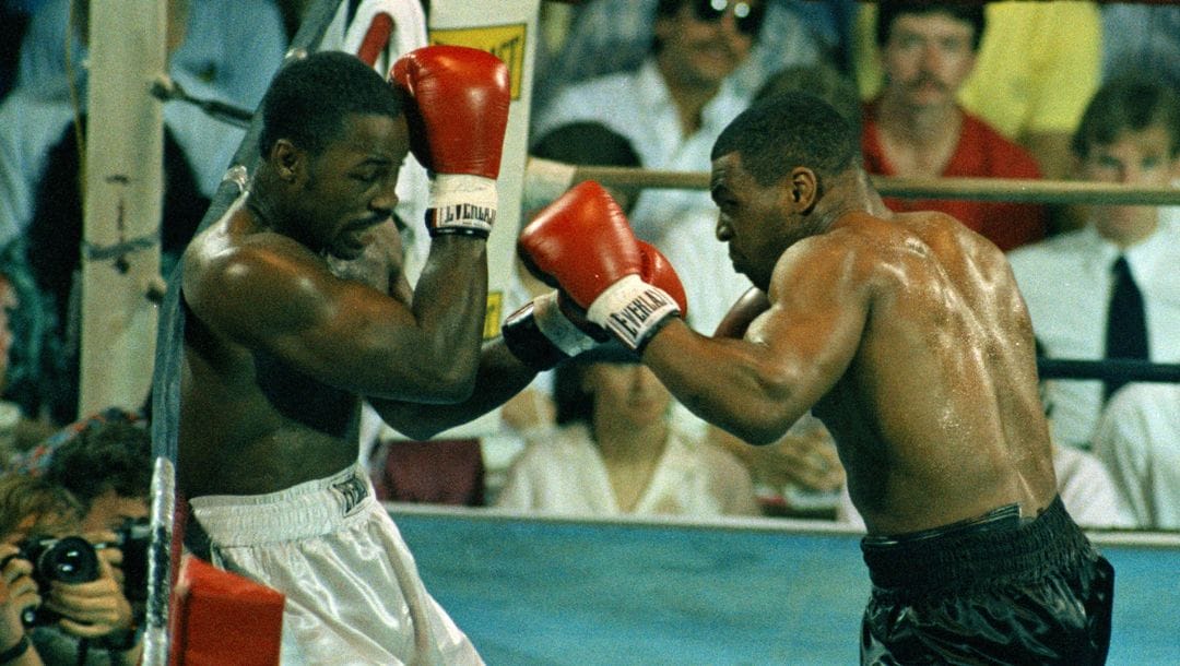 Heavyweight boxer Mike Tyson, right, throws a punch at Marvis Frazier in the first round of action at the Glen Falls Civic Center.