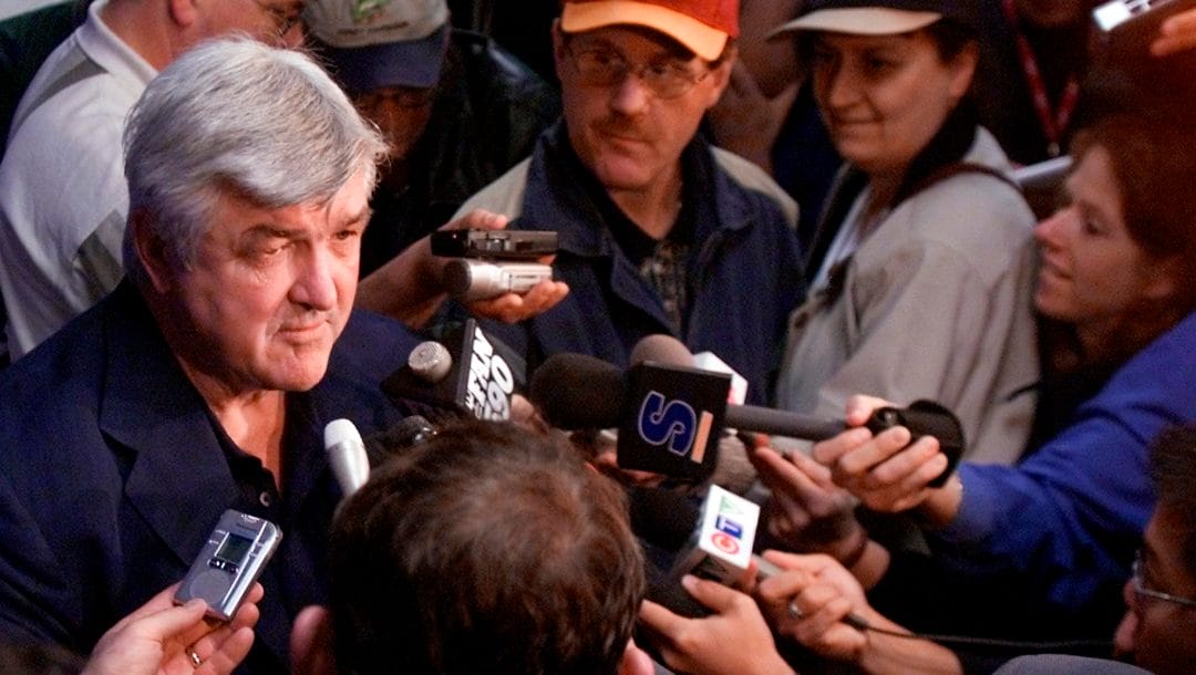 Toronto Maple Leafs coach Pat Quinn, left, is surrounded by the media as he listens to a question during a news conference Saturday, May 18, 2002, in Raleigh, N.C. The Maple Leafs face the Carolina Hurricanes Sunday in Game 2 of the Eastern Conference finalst in Raleigh. The Maple Leafs lead the series 1-0.