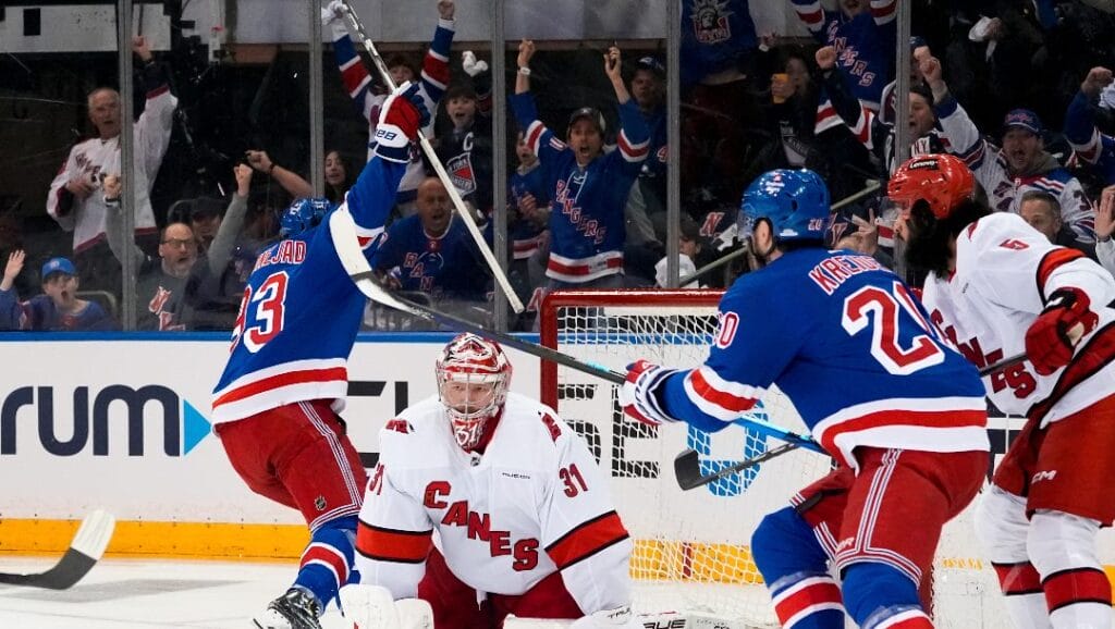 Carolina Hurricanes goaltender Frederik Andersen (31) looks on as New York Rangers center Mika Zibanejad and left wing Chris Kreider celebrate following Zibanejad's goal during the first period in Game 1 of an NHL hockey Stanley Cup second-round playoff series, Sunday, May 5, 2024, in New York.