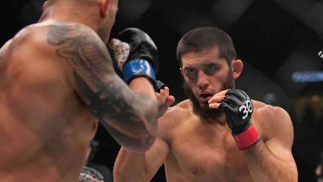 Islam Makhachev of Russia, right, battles Alex Volkanovski of Australia in the UFC lightweight championship fight during UFC 294.