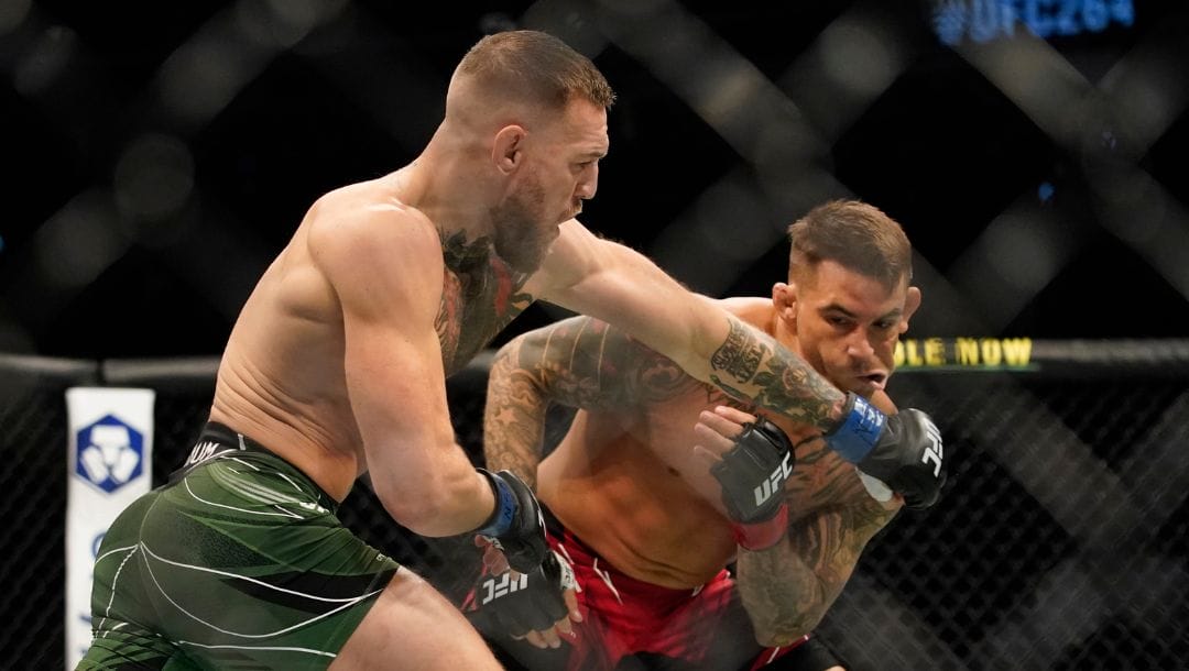 Conor McGregor, left, punches Dustin Poirier during a UFC 264 lightweight mixed martial arts bout Saturday, July 10, 2021.