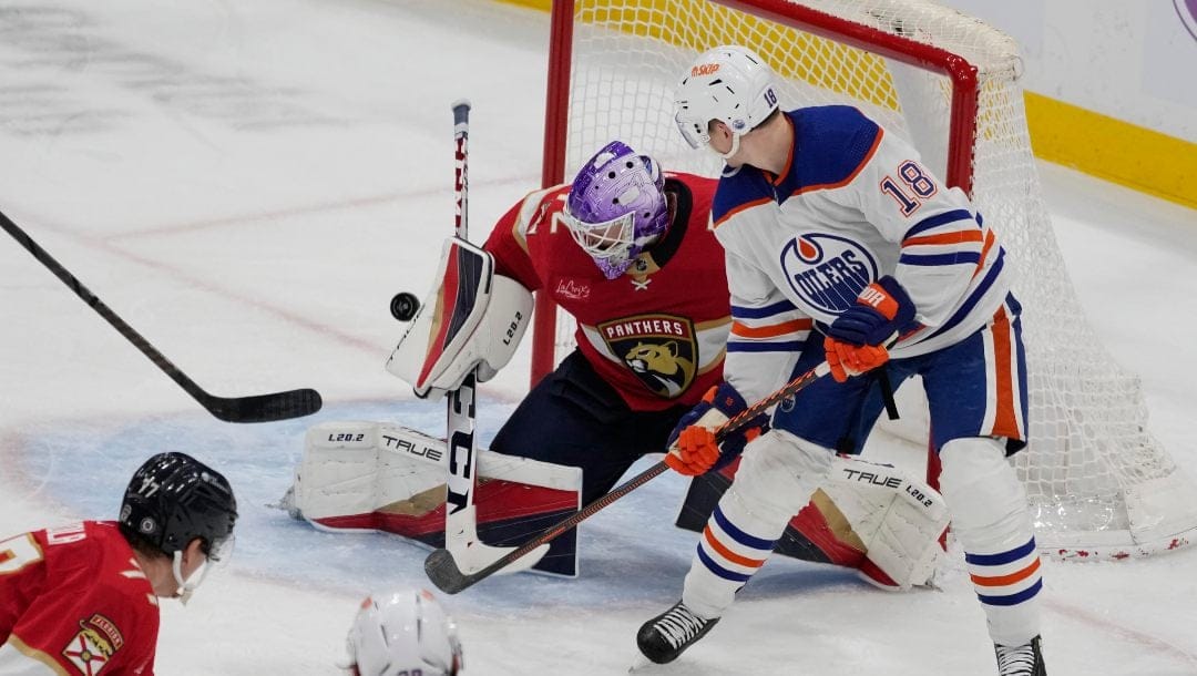 Florida Panthers goaltender Sergei Bobrovsky (72) deflects a shot on goal by Edmonton Oilers left wing Zach Hyman (18) during the third period of an NHL hockey game, Monday, Nov. 20, 2023, in Sunrise, Fla.