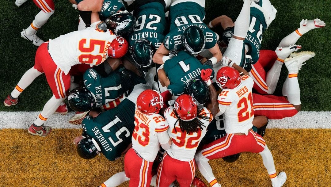 Philadelphia Eagles quarterback Jalen Hurts (1) is pushed over the goal line by teammates to a touchdown against the Kansas City Chiefs during the first half of the NFL Super Bowl 59 football game, Sunday, Feb. 9, 2025, in New Orleans.
