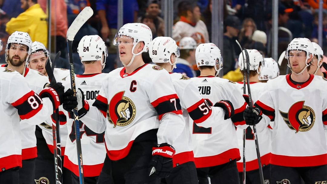 Ottawa Senators left wing Brady Tkachuk (7) celebrates with teammates after defeating the New York Islanders 4-3 in overtime in an NHL hockey game, Saturday, March 16, 2024, in Elmont, N.Y.