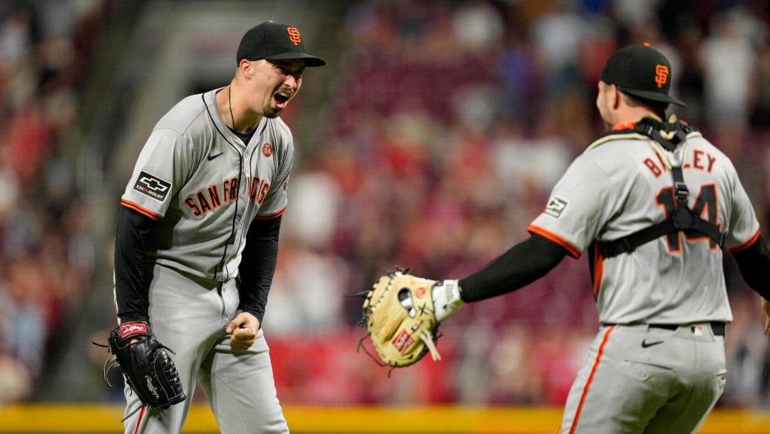 San Francisco Giants pitcher Blake Snell, left, celebrates with teammate Patrick Bailey (14) after throwing a no-hitter in nine complete innings of a baseball game against the Cincinnati Reds, Friday, Aug. 2, 2024, in Cincinnati.