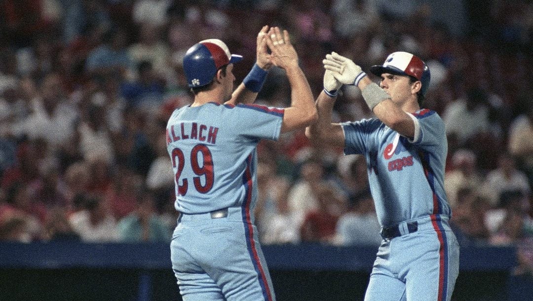 Montreal Expos' Larry Walker, right, is greeted by teammate Tim Wallach, after Walker's two-run, home run against the St. Louis Cardinals in the 5th inning of their game in St. Louis, Mo., Sept. 6, 1990. Walker's homer was the second of the game for the Expos, as Wallach hit one in the 1st inning, and the Expos defeated the Cardinals 6-2.