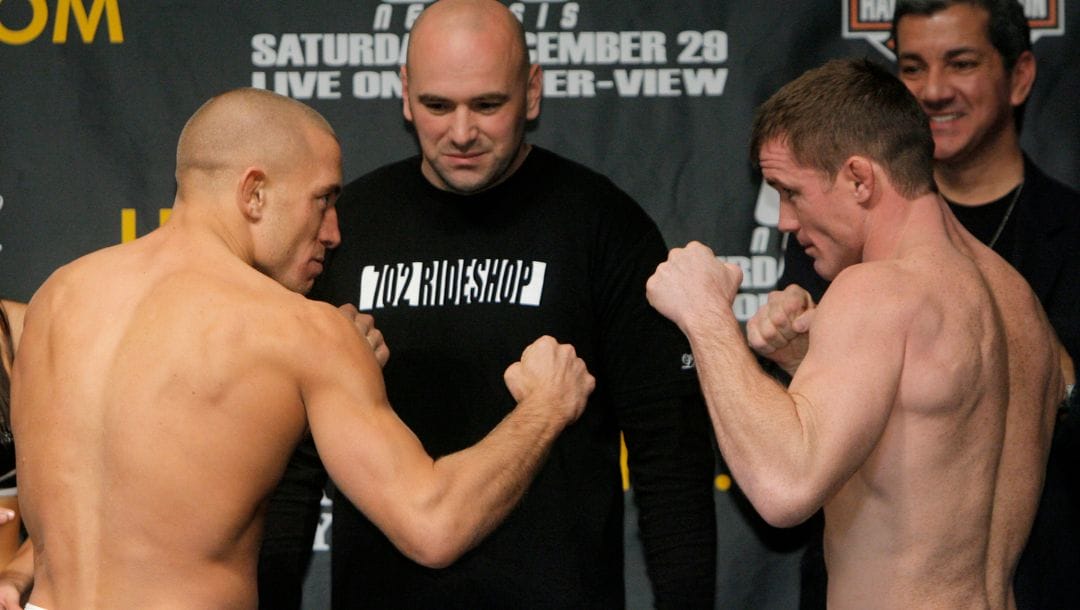 Mixed martial arts fighters Georges St. Pierre, left, of Canada, and Matt Hughes face off as UFC president Dana White.