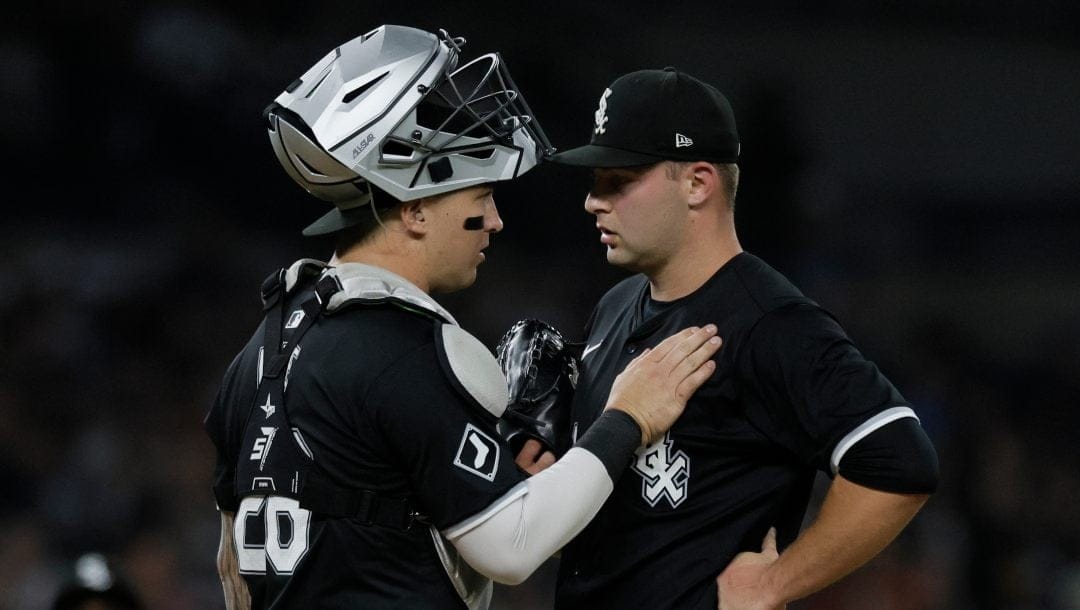 Chicago White Sox pitcher Jared Shuster, right, is visited by catcher Korey Lee (26) during the fifth inning of a baseball game against the Detroit Tigers Friday, Sept. 27, 2024, in Detroit.