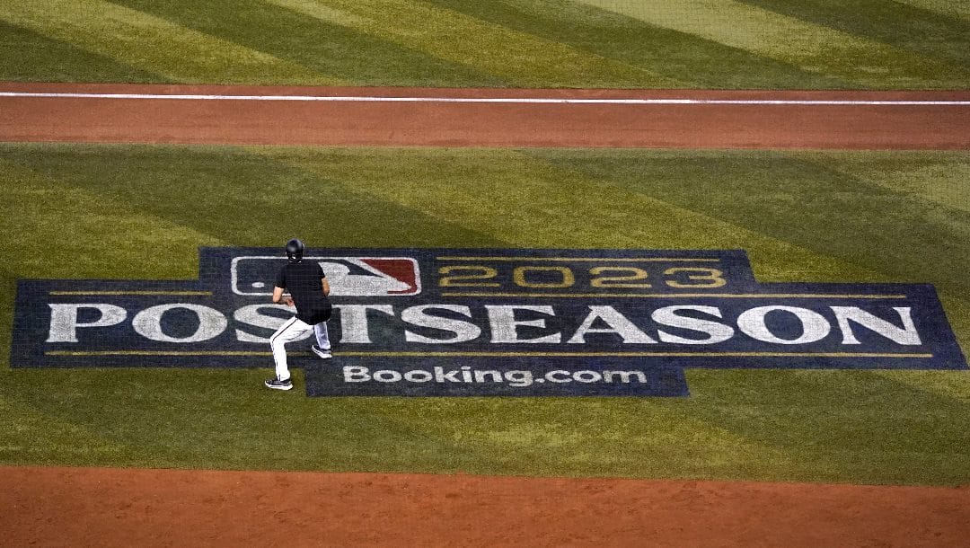 Arizona Diamondbacks third base coach Tony Perezchica stands on an MLB logo during a simulated game Friday, Oct. 13, 2023, at Chase Field in Phoenix as the team prepares to play against the Philadelphia Phillies in the baseball NL Championship Series starting Monday.
