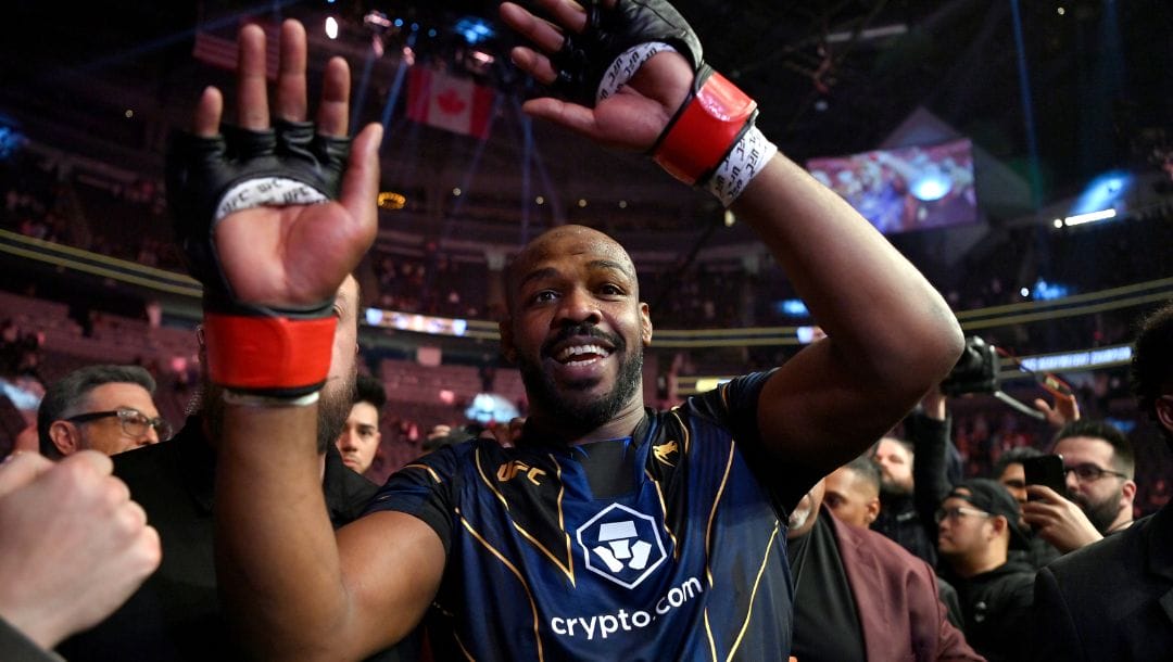 Jon Jones celebrates his victory over Ciryl Gane as he walks from the octagon after the UFC 285 mixed martial arts heavyweight.