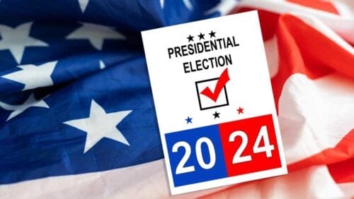 An American flag with a 2024 presidential election poster in the foreground