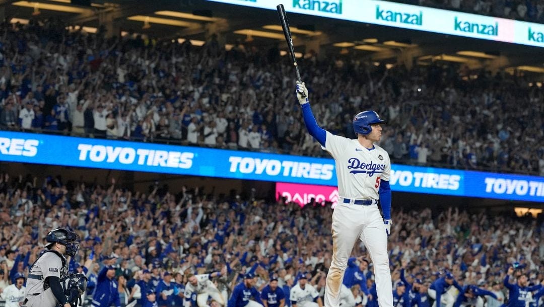 Los Angeles Dodgers' Freddie Freeman celebrates his walk-off grand slam home run against the New York Yankees during the 10th inning in Game 1 of the baseball World Series, Friday, Oct. 25, 2024, in Los Angeles.