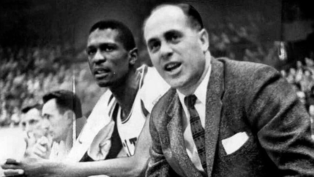 Boston Celtics center Bill Russell sitting on the bench next to head coach Red Auerbach.