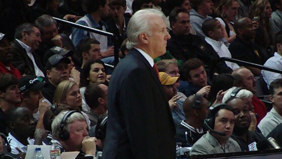 Gregg Popovich, head coach of the San Antonio Spurs, lurking on the sidelines. Photo taken during the game against the Nuggets.