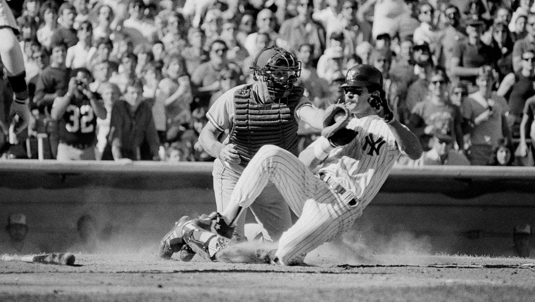 New York Yankees Don Mattingly is out at the plate after a tag by Toronto Blue Jays catcher Ernie Whitt in the fourth inning.