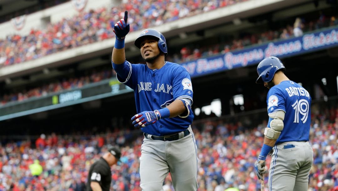 Toronto Blue Jays' Edwin Encarnacion celebrates his solo home run off a pitch from Texas Rangers' Yu Darvish in the fifth inning.