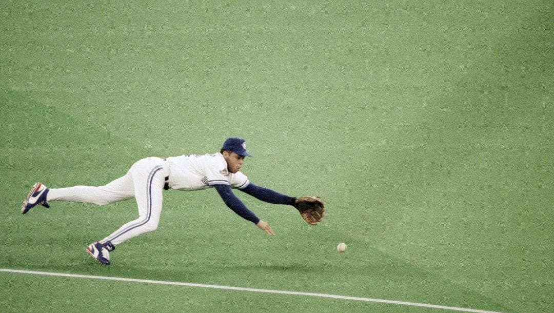 Toronto Blue Jays second baseman Roberto Alomar dives for a ground ball during game 1 of the World Series.