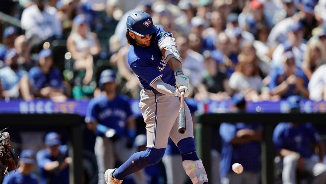 FILE -Toronto Blue Jays' Bo Bichette hits an RBI and reaches base on a fielding error by Seattle Mariners shortstop J.P. Crawford.