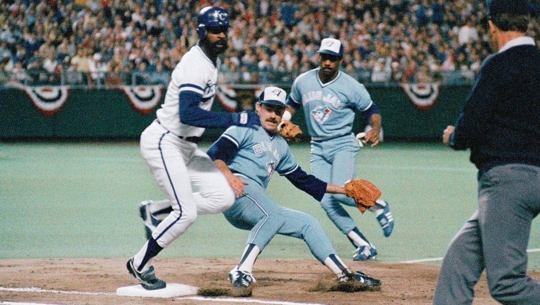 Kansas City Royals batter Willie Wilson, left, hits first base as Toronto Blue Jays pitcher Dave Stieb coves the bag on a close play in the third inning of an AL playoff game, Saturday, Oct. 12, 1985, Kansas City, Mo. Wilson was ruled safe on the play. Stieb had taken the throw from the Jays first baseman Willie Upshaw, rear.