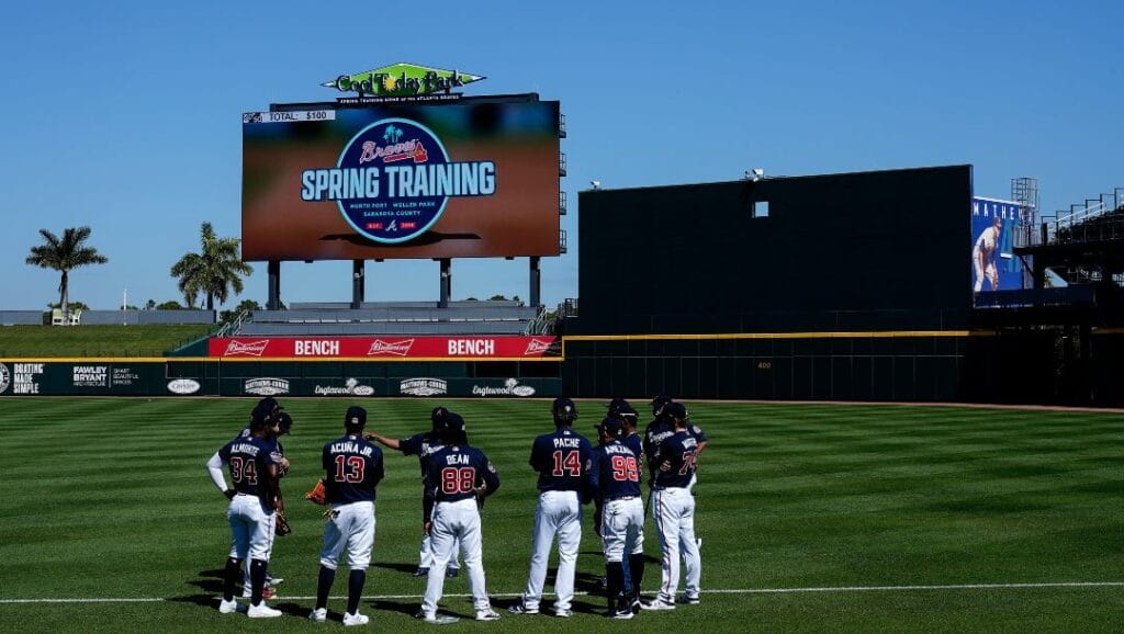 Atlanta Braves first base coach Eric Young talks with the players during spring training baseball practice on Tuesday, Feb. 23, 2021, in North Port, Fla.