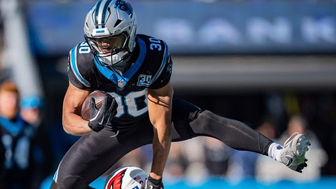 Carolina Panthers running back Chuba Hubbard (30) hurdles over Arizona Cardinals cornerback Sean Murphy-Bunting (23) during an NFL football game between the Carolina Panthers and the Arizona Cardinals on Sunday, Dec. 22, 2024, in Charlotte, N.C.