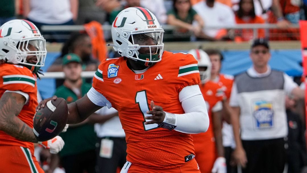 Miami quarterback Cam Ward (1) throws a pass during the first half of the Pop Tarts Bowl NCAA college football game.